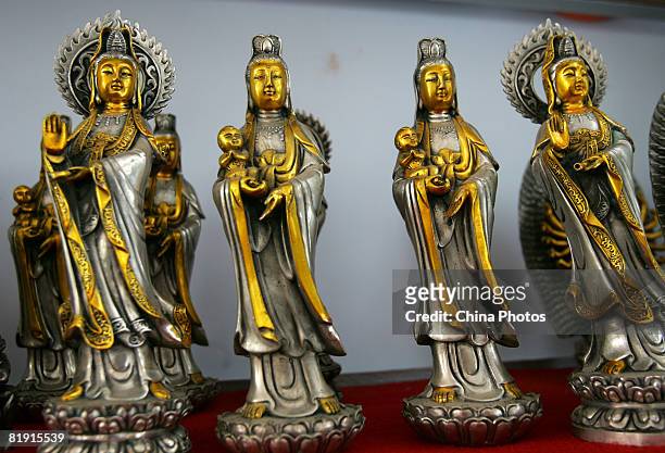Bronze sculptures of Goddess of Mercy are displayed in the bronze factory at Gezhai Village on July 12, 2008 in Yichuan County of Henan Province,...