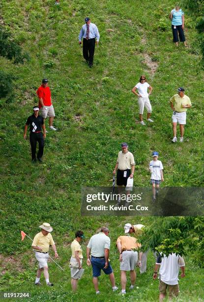 Eric Axley walks to his ball after a fan finally found it among deep rough in the woods on the fourth hole during the third round of the 2008 John...