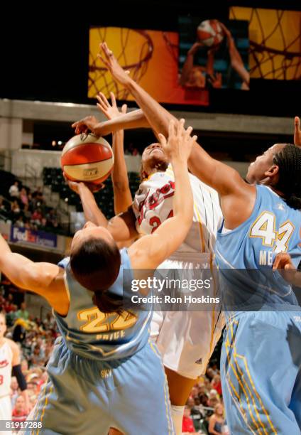 Tamika Catchings of the Indiana Fever battles Armintie Price and Chasity Melvin of the Chicago Sky at Conseco Fieldhouse on July 12, 2008 in...