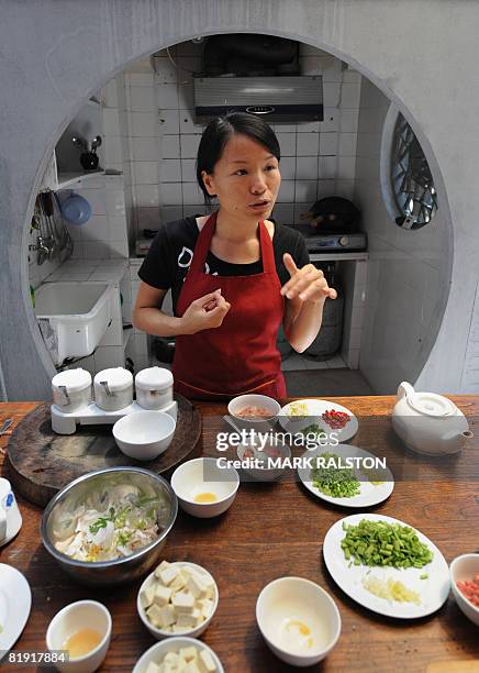 By Gersende RAMBOURG Chinese chef Zhou Chunyi conducts a cooking class for foreigners at her traditional "Hutong" courtyard style house in Beijing on...