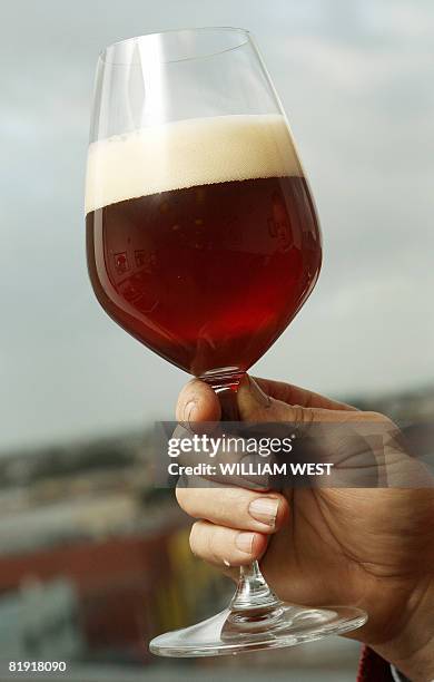 Lifestyle-Australia-drink-beer, by Neil Sands Carlton's master brewer John Cozens holds a glass of the Carlton & United Breweries' Crown Ambassador...