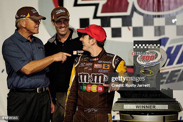 Team owners Joe Gibbs and JD Gibbs celebrate in Victory Lane with their driver Kyle Busch, driver of the M&Ms Toyota after winning the NASCAR Sprint...