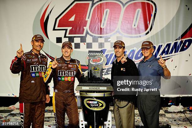 Kyle Busch , driver of the M&Ms Toyota celebrates in victory lane with crew chief Steve Addington and team owners J.D. Gibbs and Joe Gibbs winning...