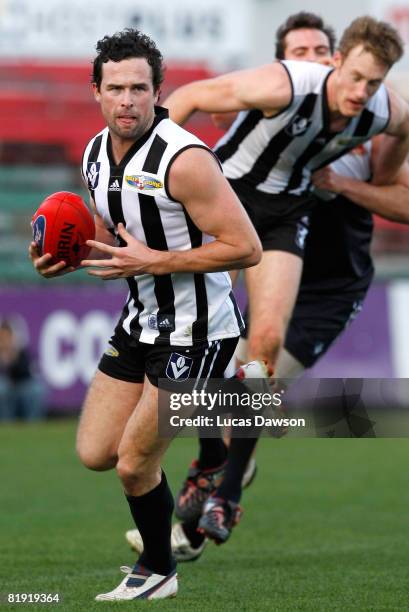 Ryan Lonie of Collingwood looks for a team-mate during the round 14 VFL match between Collingwood Magpies and the North Ballarat Roosters at Princes...