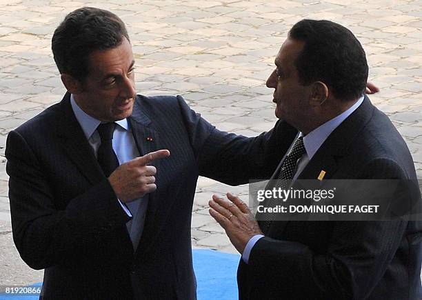 France's President Nicolas Sarkozy welcomes Egypt's President and summit co-chairman Hosni Mubarak as he arrives to attend the Paris' Union for the...