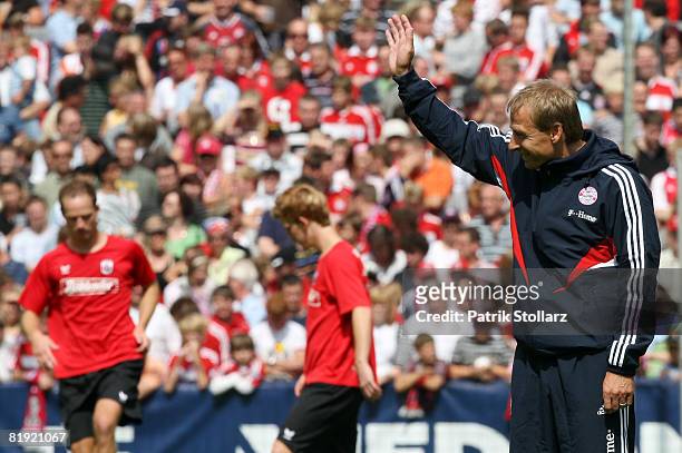 Juergen Klinsmann of Munich waves prior to a friendly match between SV Lippstadt 08 and FC Bayern Munich at the 'Am Waldschloesschen' stadium on July...