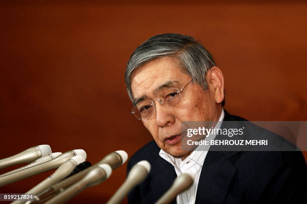 Bank of Japan governor Haruhiko Kuroda listens to a question during a press conference in Tokyo on July 20, 2017. The Bank of Japan slashed its...
