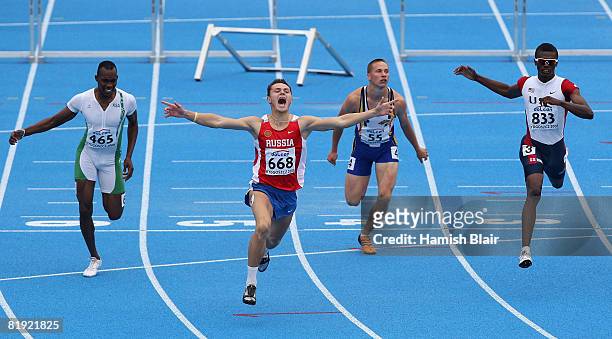 Konstantin Shabanov of Russia celebrates his win in the final of the men's 110m hurdles alongside 2nd placed Booker Nunley of USA, 4th placed Sami...