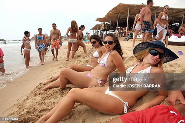 Lebanese enjoy the beach prior to the a swim wear and lingerie fashion show at an up market beach resort in the ancient city of Byblos north of...