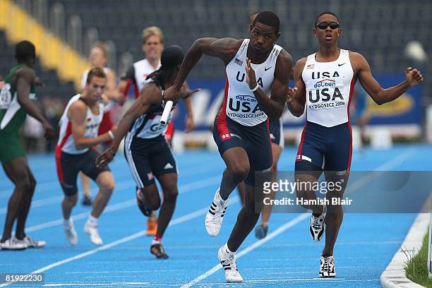 Neal Wilder of USA starts off on the 3rd leg after receiving the baton from team mate Bryan Miller on their way to victory in the final of the 4x400m...