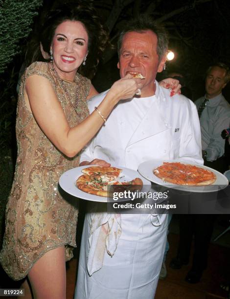 Celebrity chef Wolfgang Puck and his wife Barbara Lazaroff show off their trademark pizzas at the Spago closing party March 28, 2001 in West...