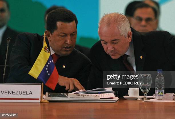 Venezuela's President Hugo Chavez speaks with his Minister of Energy and President of the state-owned oil company PDVSA Rafael Ramirez on July 13,...