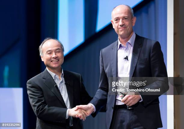 SoftBank Group Corp. Chief Executive Officer Masayoshi Son, left, shakes hands with ARM Holdings Plc Chief Executive Officer Simon Segars during the...
