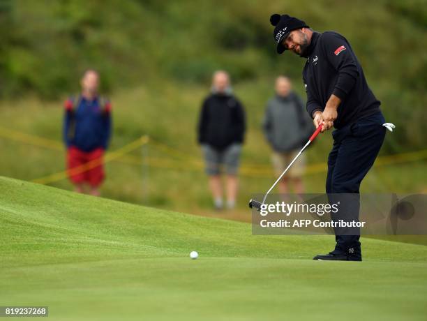 Golfer Ryan Moore putts on the 8th green during his opening round on the first day of the Open Golf Championship at Royal Birkdale golf course near...