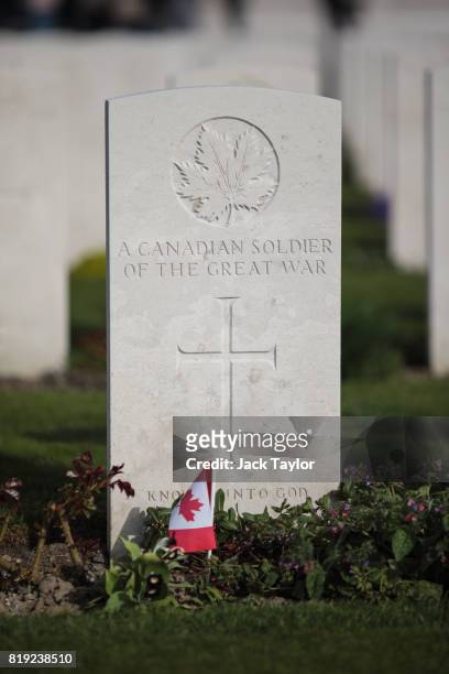 Canadian flag sits in front of the headstone of the grave of a Canadian soldier at Tyne Cot Cemetery on April 5, 2017 in Zonnebeke, Belgium. July...
