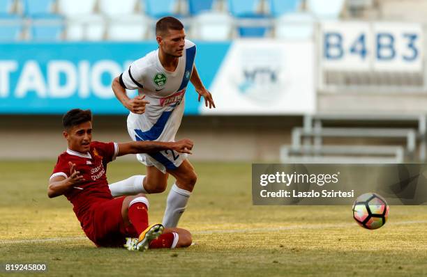 Milan Sagi of MTK Budapest II fouls Yan Dhanda of FC Liverpool U23 during the Preseason Friendly match between MTK Budapest II and FC Liverpool U23...