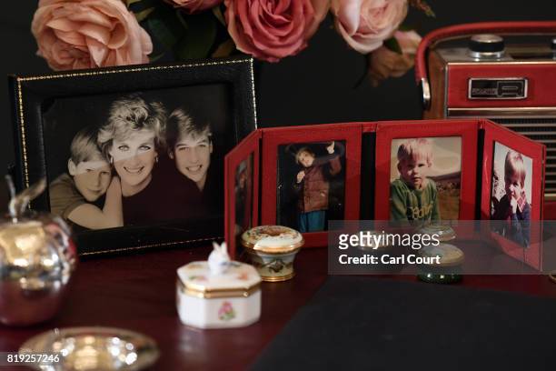 Photographs of Princes William and Harry and Princess Diana are displayed on a desk used by Princess Diana in Kensington Palace at the Royal Gifts...