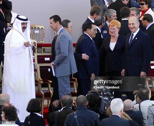 In this handout photo provided by the Israeli Government Press Office , Qatari Emir Hamad bin Khalifa al-Thani speaks with Syrian President Bashar...