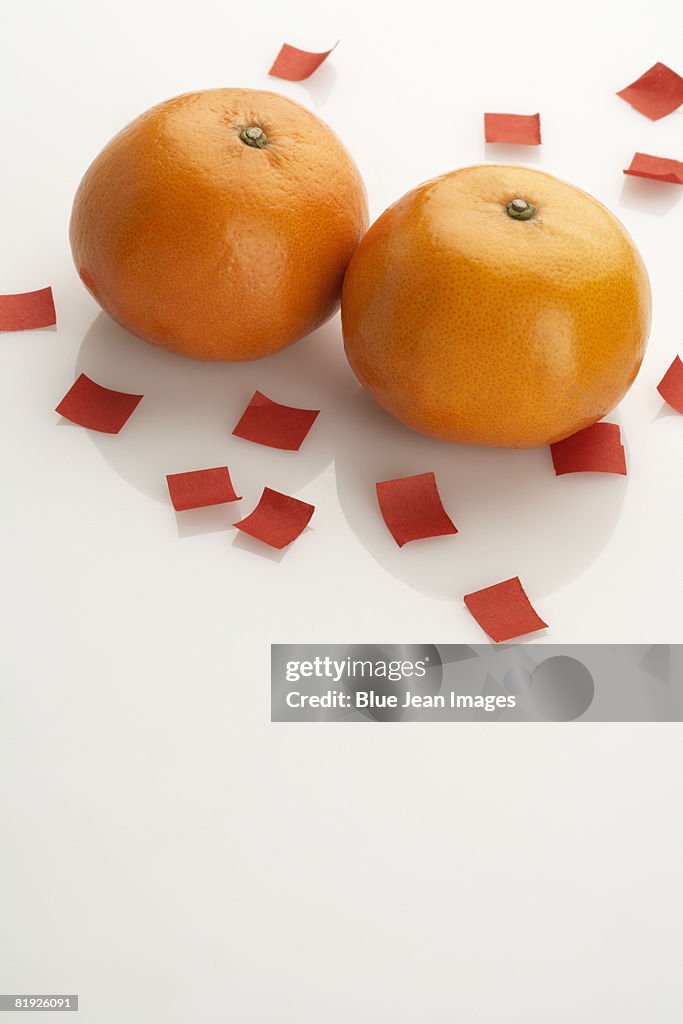 Two oranges on festive Chinese paper
