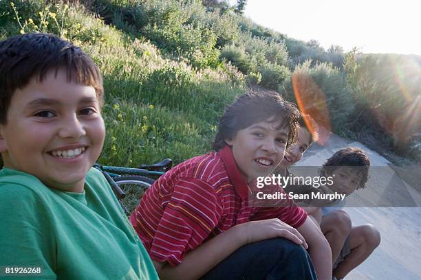 young boys hanging out near a drainage ditch - la four stock pictures, royalty-free photos & images