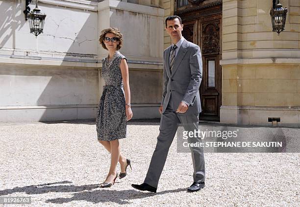 Syrian President Bashar al-Assad and his wife Asma arrive at the Hotel Marigny on July 14, 2008 in Paris, to attend the traditional garden party as...