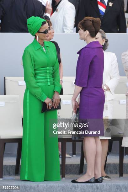 Sheikha Moza Bint Nasser al-Misnad, wife of the Qatari Emir, and French first lady Carla Bruni-Sarkozy attend the Bastille Day ceremony on July 14,...