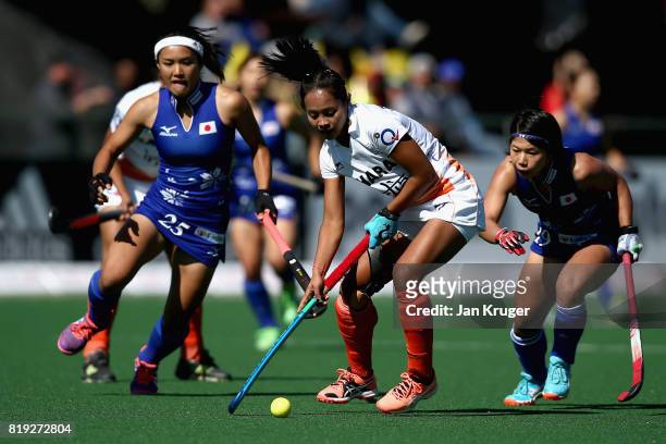 Sushila Pukhrambam of India attempts to take the ball away from Motomi Kawamura of Japan and Akiko Kato of Japan during the 5th-8th Place playoff...