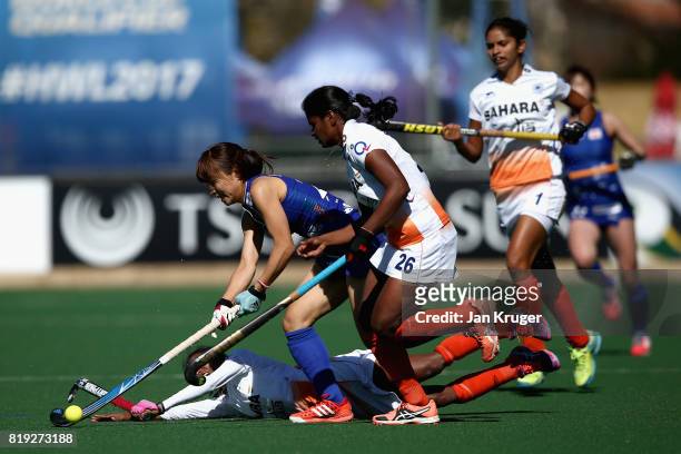 Minami Shimizu of Japan attempts to keep possesion while under pressure from Nikki Pradhan of India and Sunita Lakra of India during the 5th-8th...