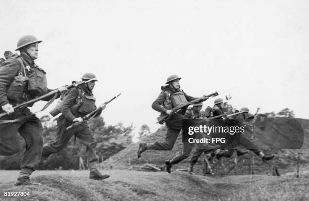 Czechoslovak infantry troops take part in a bayonet charge whilst training in Britain during World War II, circa 1940.