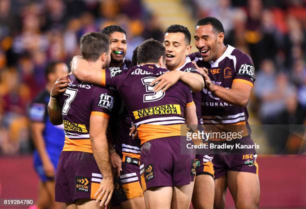 Kodi Nikorima of the Broncos is congratulated by team mates after scoring a try during the round 20 NRL match between the Brisbane Broncos and the...