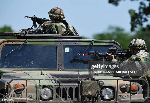 Soldiers secure the area at a new installed check-point at Babadag training facility in the county of Tulcea, during a joint task force-east rotation...