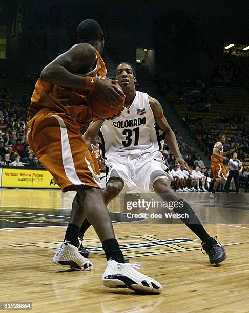 Jermyl Jackson-Wilson of the University of Colorado guarding Damion James during a game against University of Texas at Coors Arena, Boulder,...