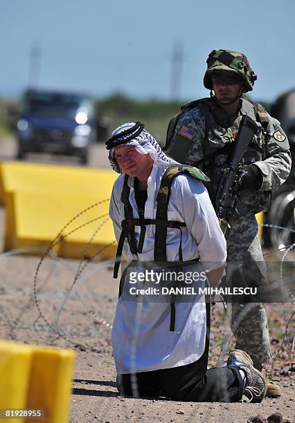 Soldier arrests a mock suspect wearing arab outfits on July 14, 2008 at Babadag training facility in the county of Tulcea, at the Joint Task...