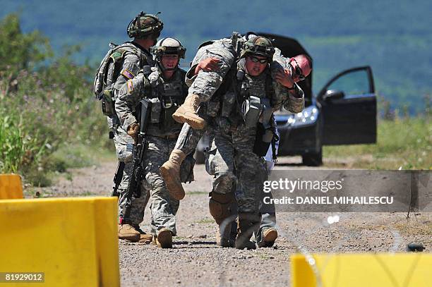 Soldier carries a wounded mock on July 14, 2008 at Babadag training facility in the county of Tulcea, at the Joint Task Force-East Rotation 2008...