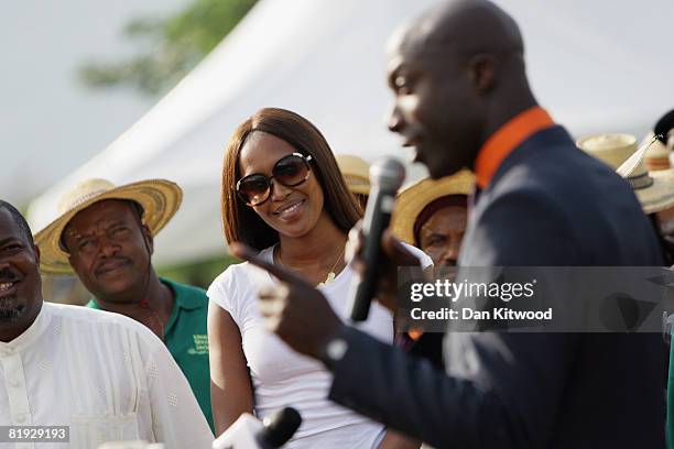 Super model Naomi Campbell and British Taylor Oswald Boateng wait to plant a Cocoa Tree in Abuja Central Park and Botanical Gardens on July 11, 2008...