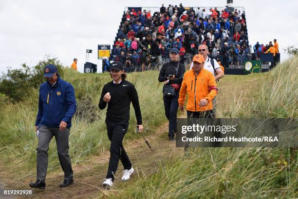 Tommy Fleetwood of England walks off the 7th tee chatting to an official during the first round of the 146th Open Championship at Royal Birkdale on...