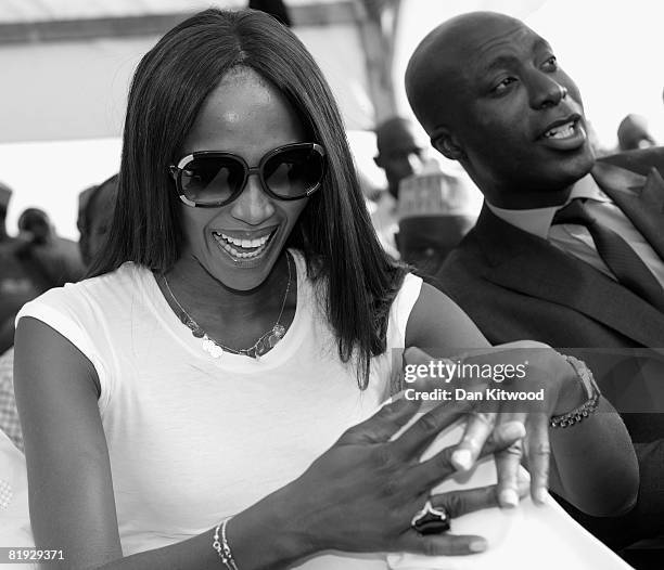 Super model Naomi Campbell and British Taylor Oswald Boateng wait to plant a Cocoa Tree in Abuja Central Park and Botanical Gardens on July 11, 2008...