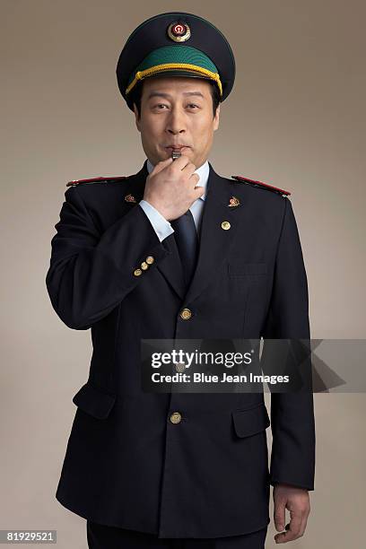 chinese train conductor blowing whistle - train guard stock pictures, royalty-free photos & images