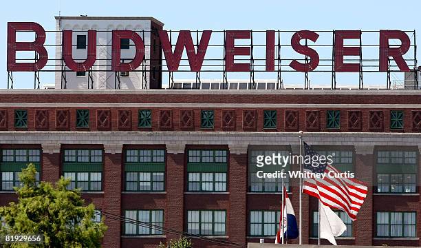 Flags fly in front of the packaging plant for Anheuser-Busch Cos. July 14, 2008 in St. Louis, Missouri. Anheuser-Busch Cos. Inc.'s board of directors...
