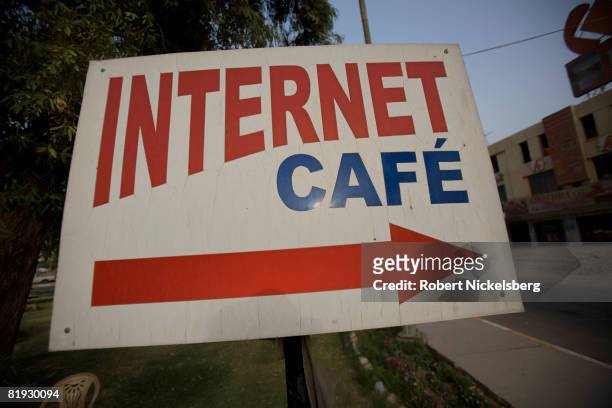 Sign points to an internet cafe in central Baghdad, Iraq May 27, 2008 in Baghdad, Iraq. In the past few years, internet cafes have become a more...