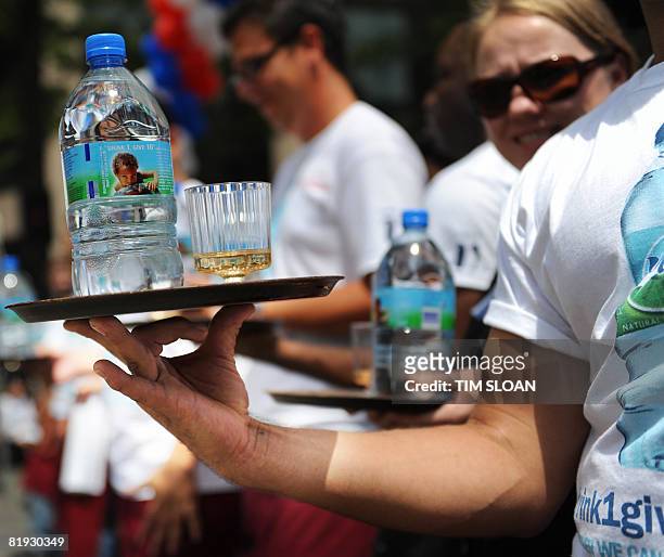 Participant shows his technique to carry a tray with a bottle of water and a glass of champgne blalanced upon it during The Brasserie Les Halles 34th...