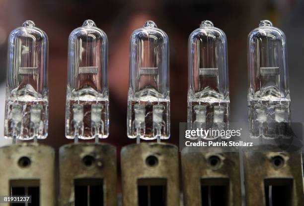 Worker of Philips controls a halogen lamp at the production line on July 14, 2008 in Aachen, Germany.