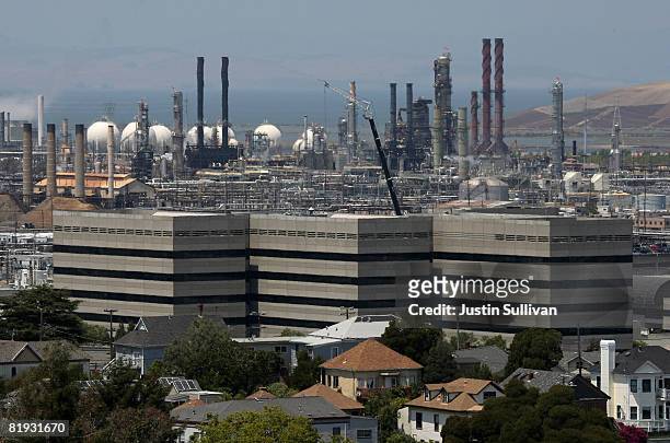 Homes stand amidst the Chevron oil refinery July 14, 2008 in Richmond, California. As gasoline prices continue to climb to a national average of...