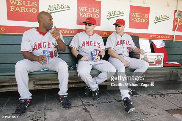 Torii Hunter, Reggie Willits and Robb Quinlan of the Los Angeles Angels talk in the dugout prior to the game against the Oakland Athletics at McAfee...