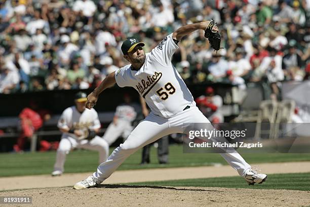 Andrew Brown of the Oakland Athletics pitches during the game against the Los Angeles Angels at McAfee Coliseum in Oakland, California on June 8,...