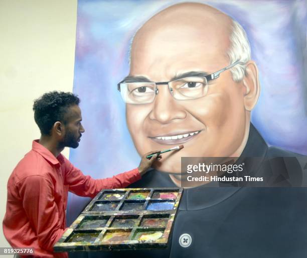 Artist Jagjot Singh Rubal touches up his painting of the newly elected President of India, Ram Nath Kovind, at his home on July 20, 2017 in Amritsar,...