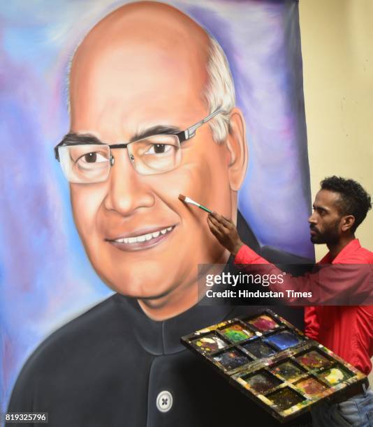 Artist Jagjot Singh Rubal touches up his painting of the newly elected President of India, Ram Nath Kovind, at his home on July 20, 2017 in Amritsar,...