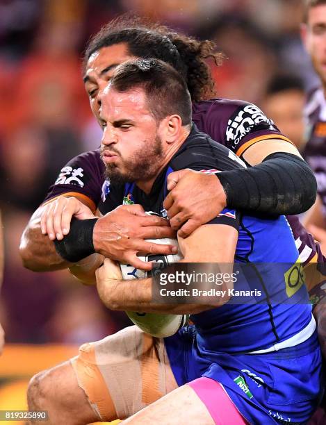Josh Reynolds of the Bulldogs is tackled by Adam Blair of the Broncos during the round 20 NRL match between the Brisbane Broncos and the Canterbury...