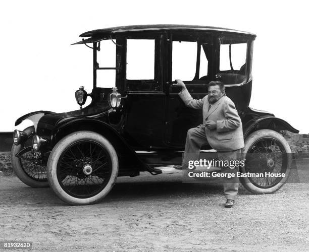 The mathematician and electrical engineer Charles Proteus Steinmetz standing beside a Detroit Electric touring automobile, produced by Detroit's...