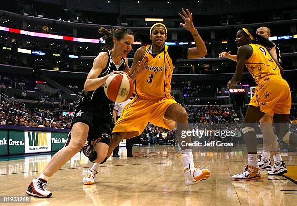 Erin Buescher of the San Antonio Silver Stars drives the ball past Candace Parker of the Los Angeles Sparks during the game on July 14, 2008 at the...